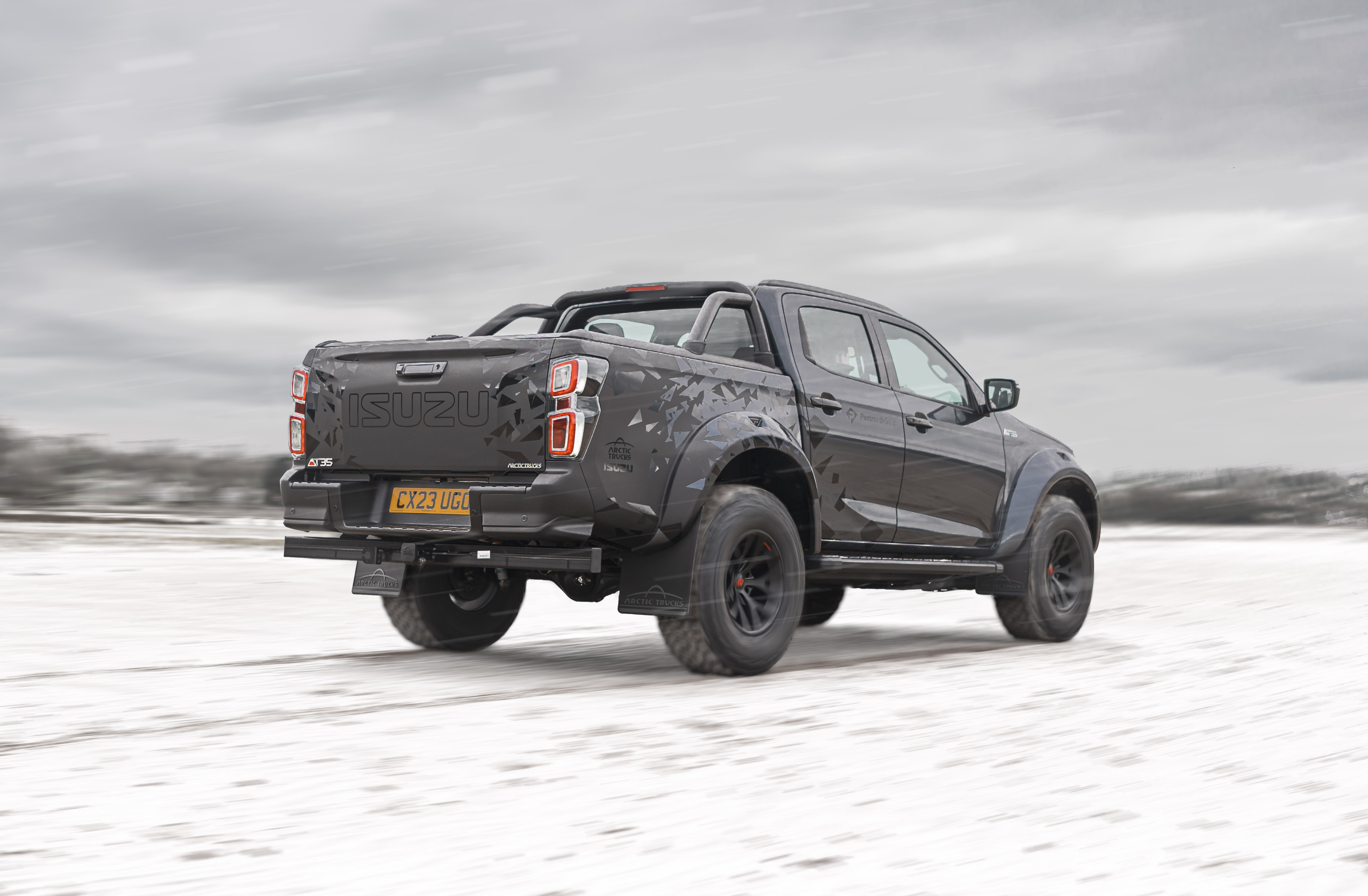 Rear view of an Isuzu Arctic Truck in a snowy field