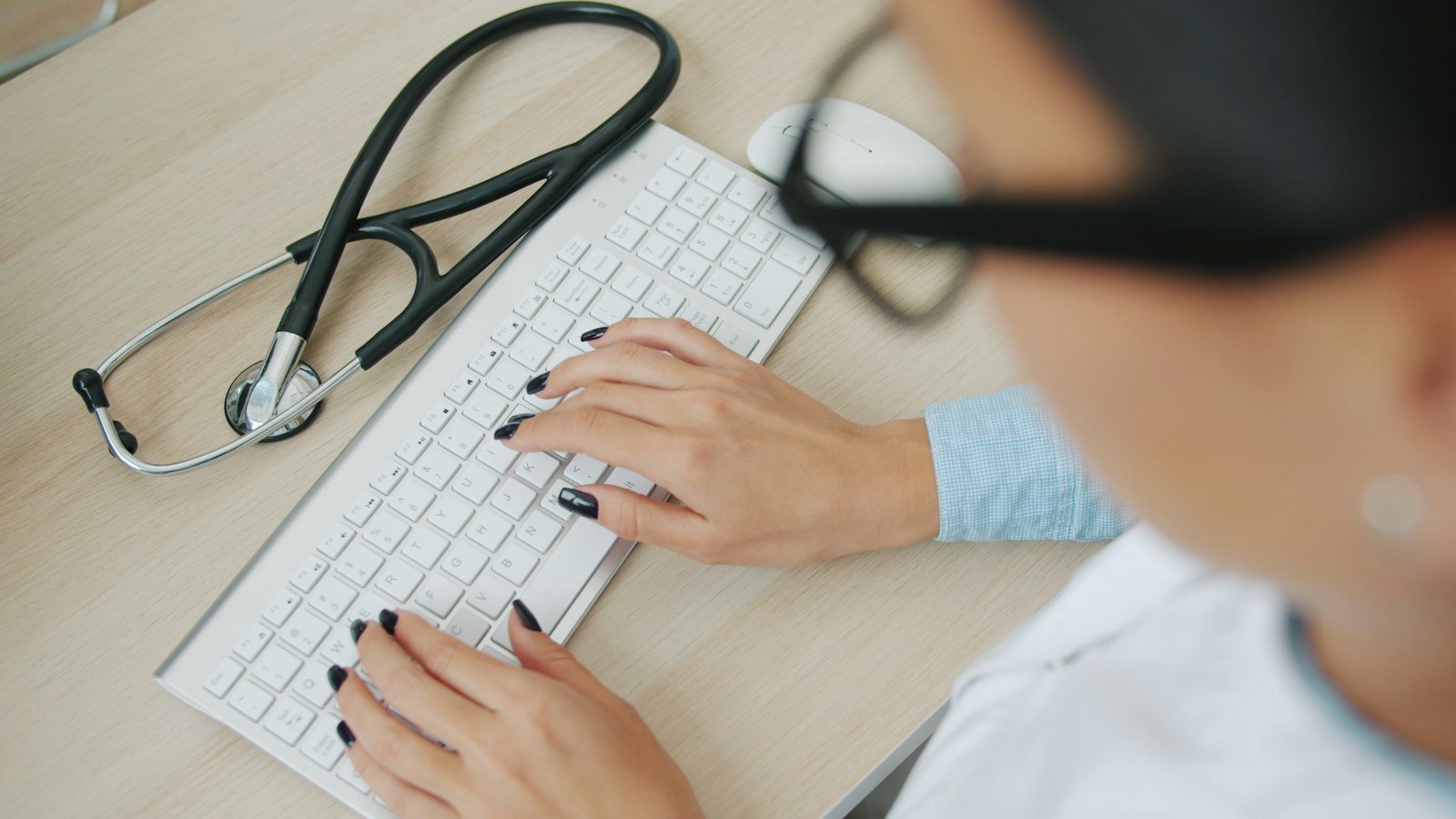 Medical office staff typing on a keyboard