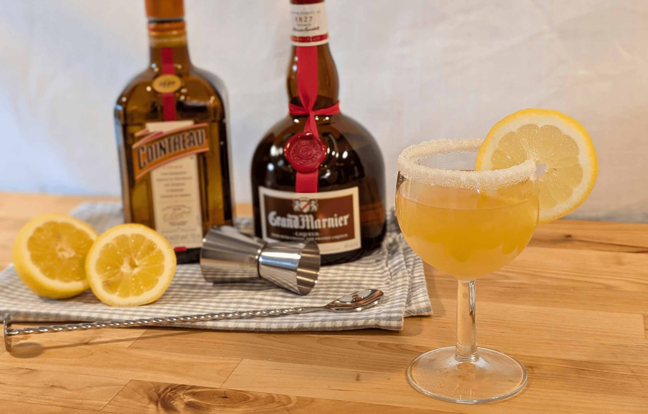 Sidecar cocktail with a sugar rim and lemon wheel