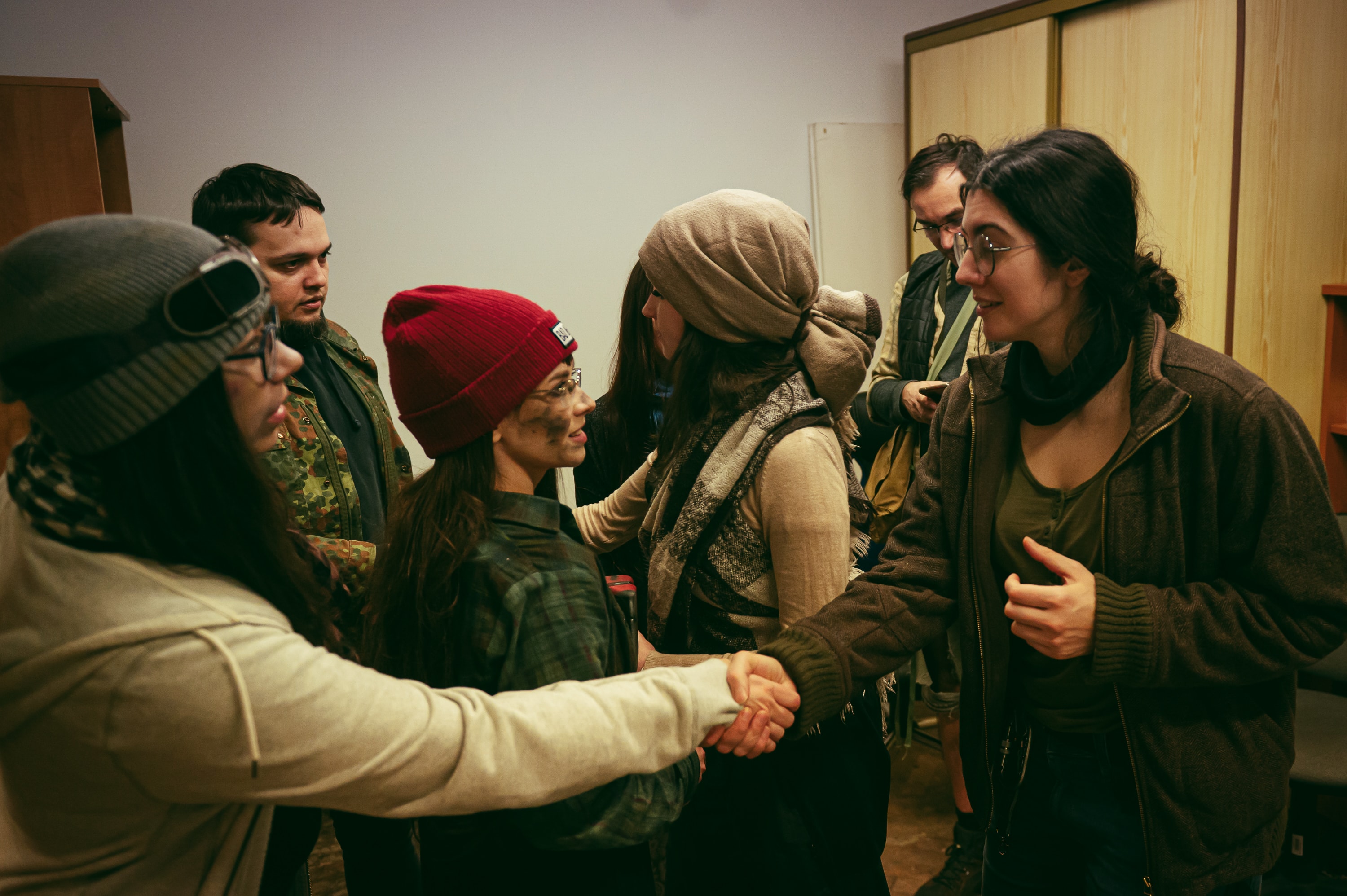 Costumed game night guests shaking hands