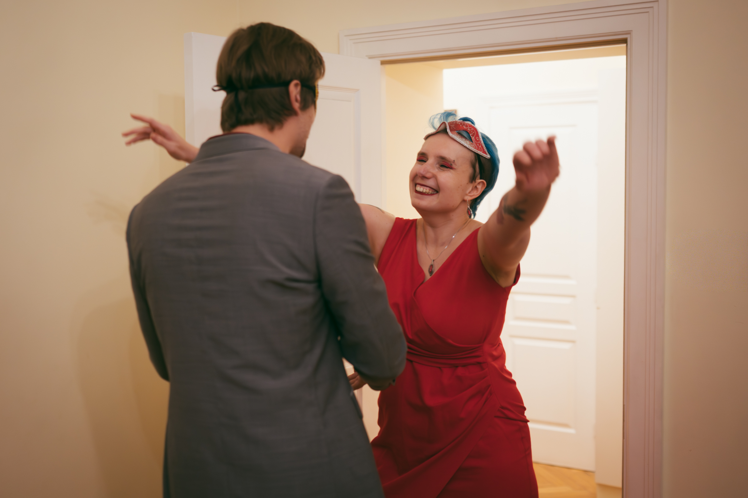 Murder mystery party guest greeted by host at the door