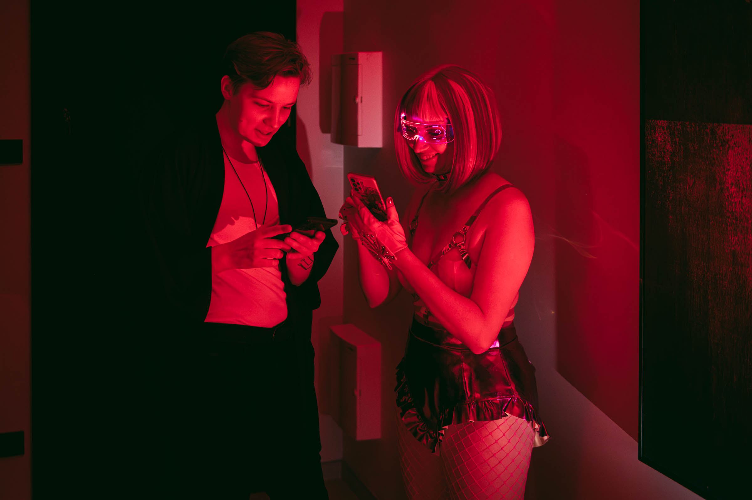 Guests using a murder mystery party app on their phones