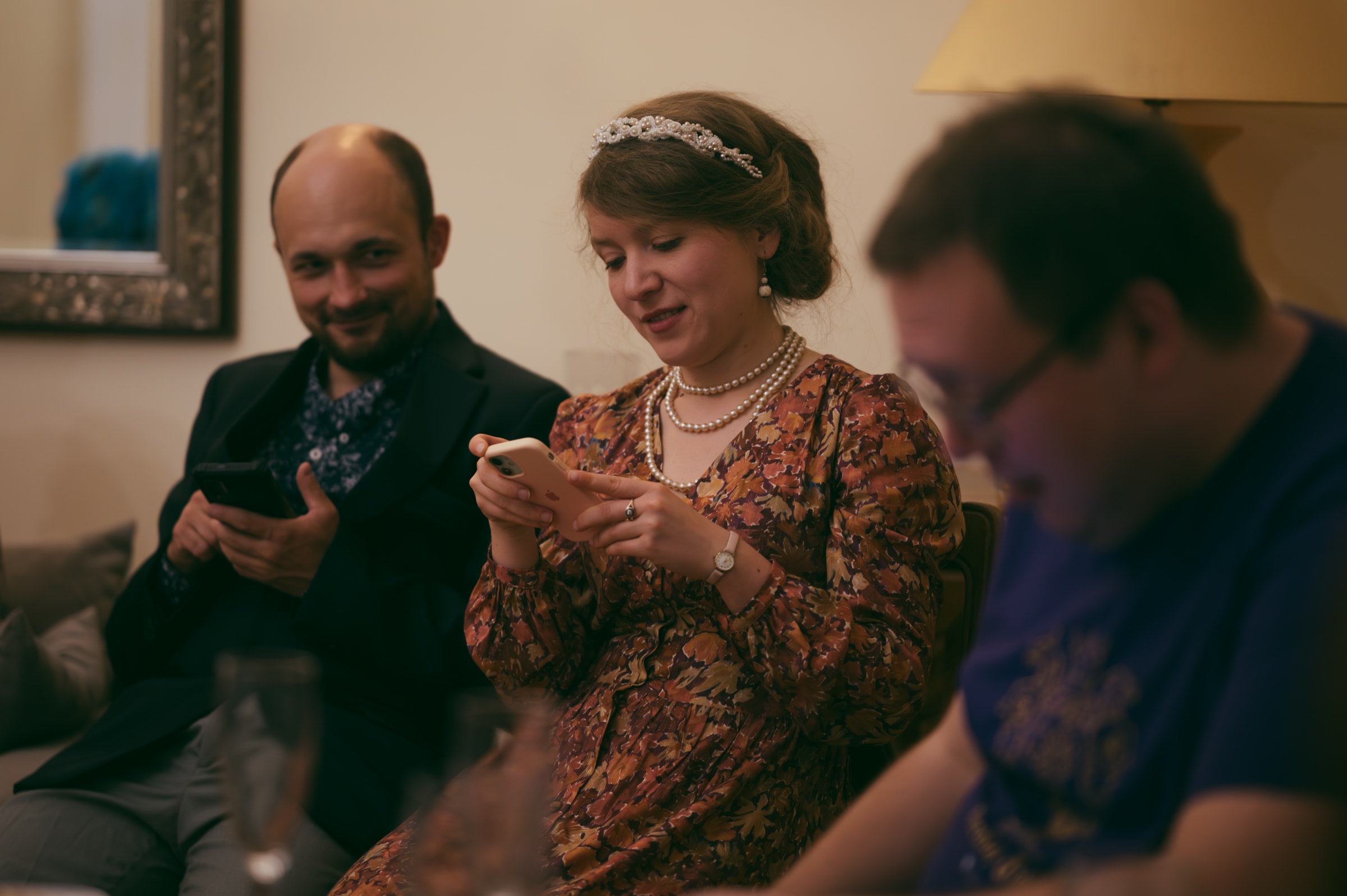 costume party guests using their phones