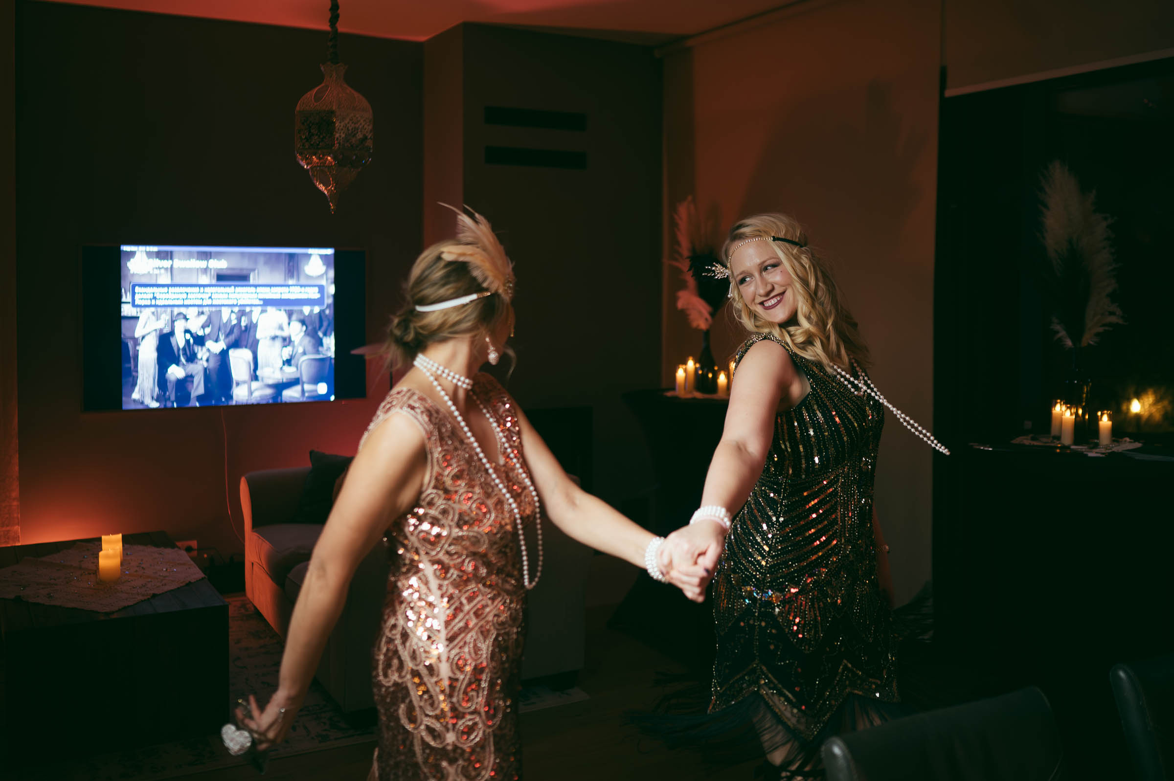 Two women in 1920s flapper costumes dancing