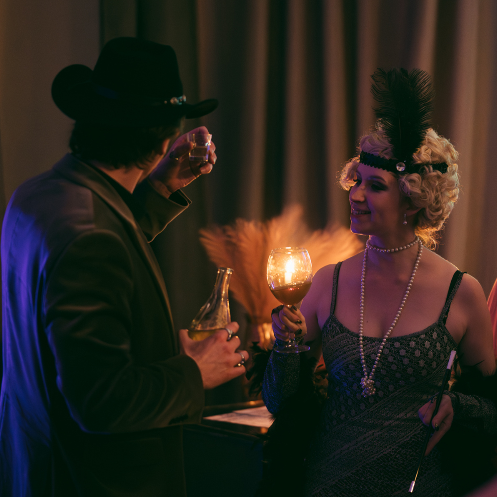 Two people in 1920s costumes at a party