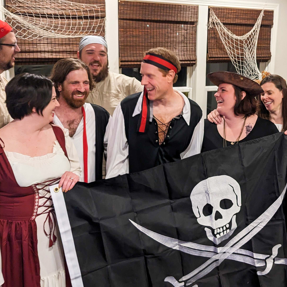 Laughing people at a pirate theme party