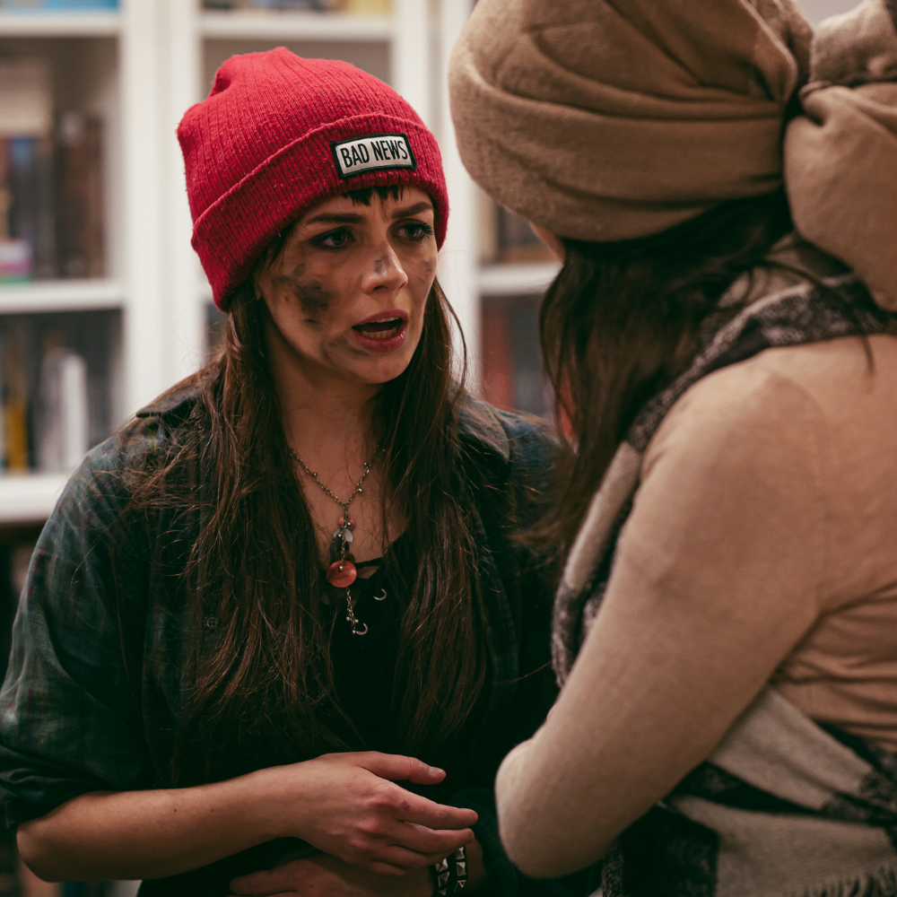 People talking in zombie apocalypse party costumes