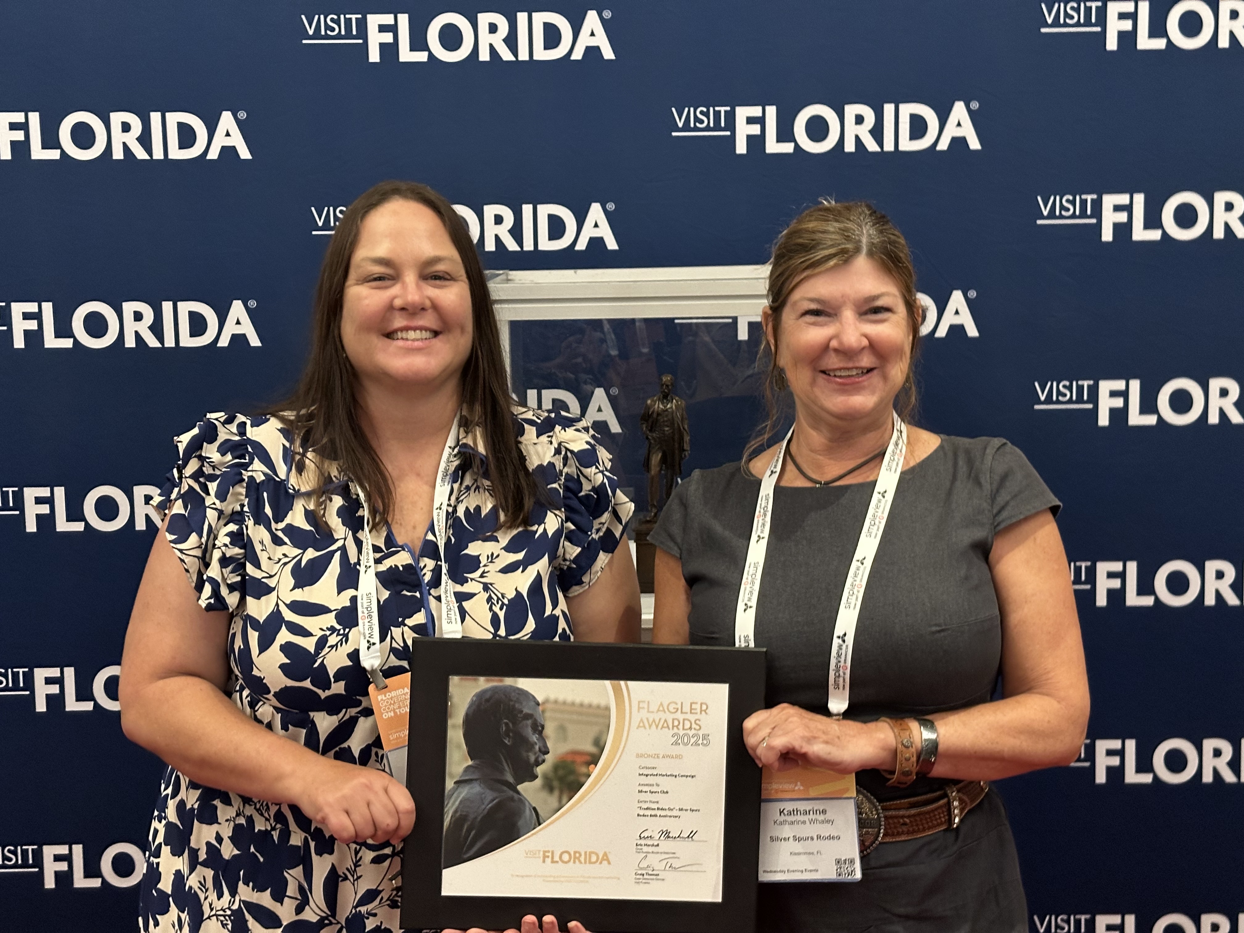 Sara Berlinsky and Katharine “Kaye” Whaley holding the Flagler Award on behalf of Silver Spurs Club.