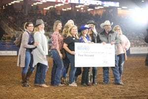 silver spurs rodeo presenting a check