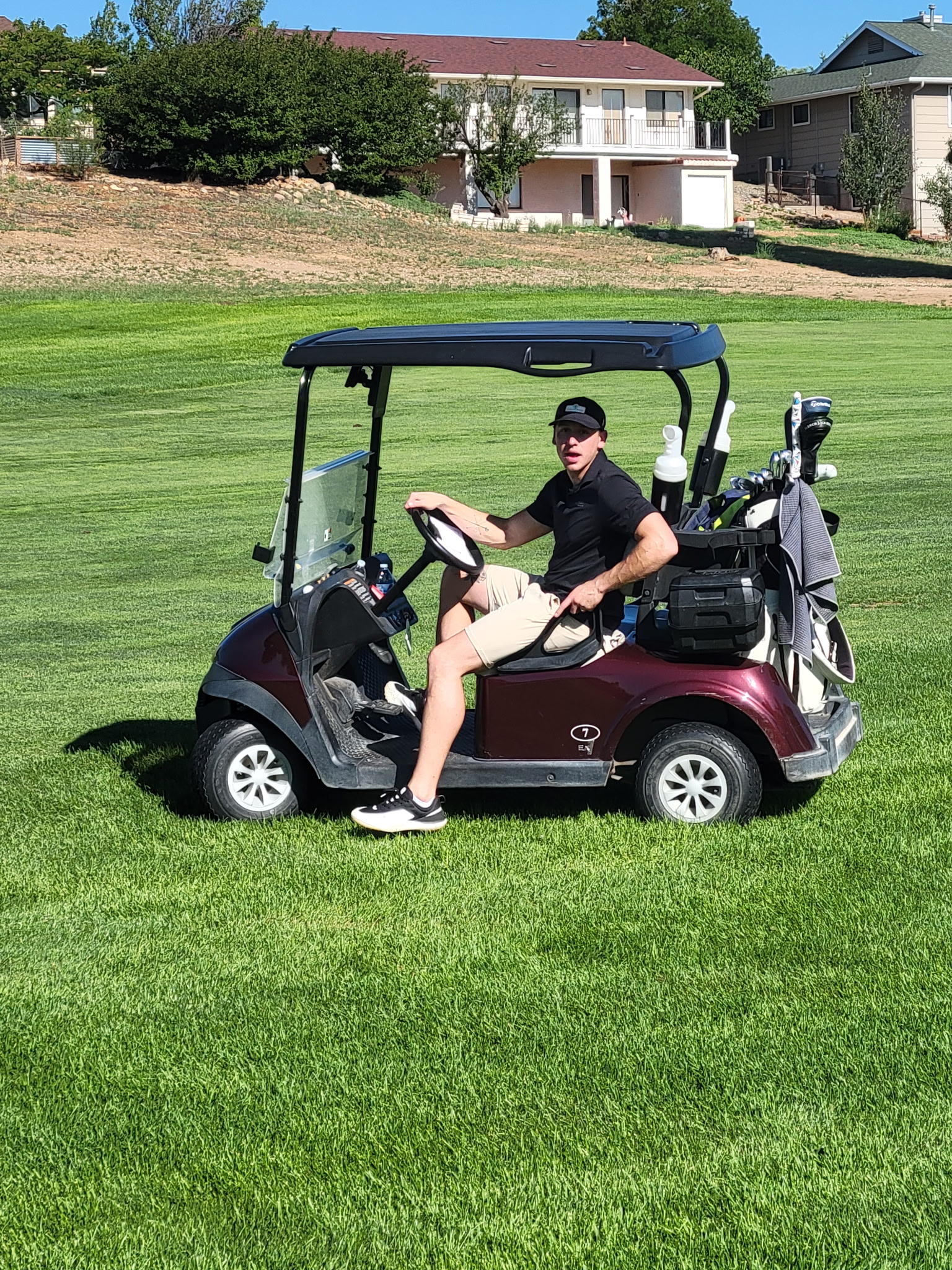 Jon L. laughing on a golf cart