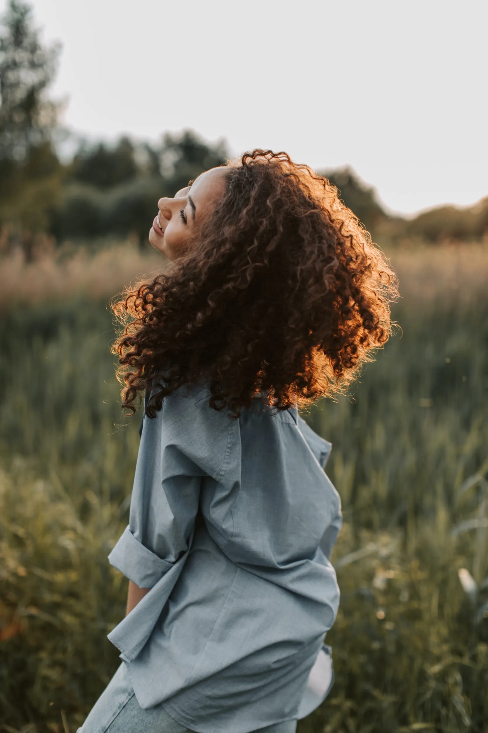 A woman standing in a field of tall grass