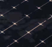 Close-up of a solar panel surface with reflective, grid-like pattern under light.