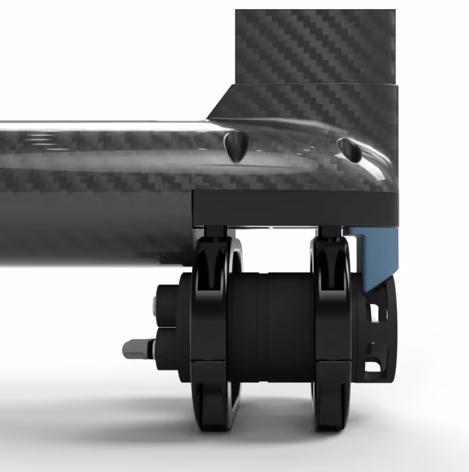 Close-up of a black mechanical component attached to a carbon fiber structure on a white background.