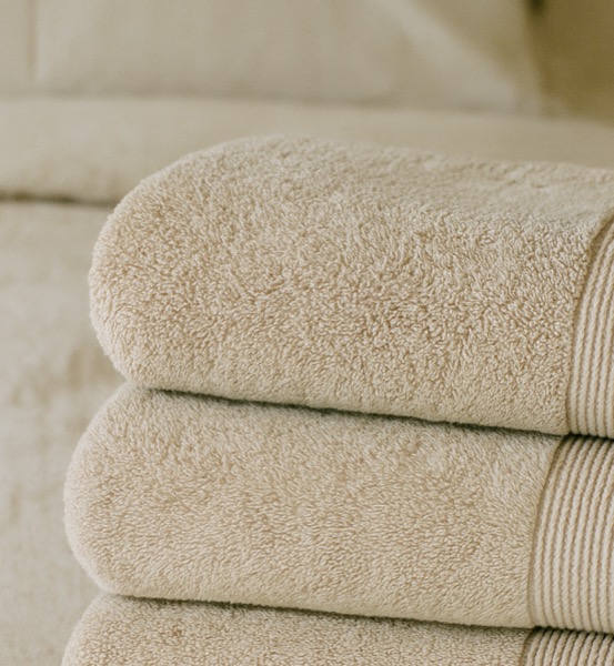 Folded towels and fresh bedding