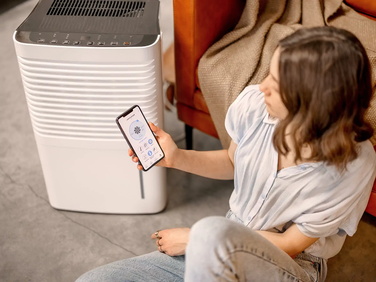 A homeowner checks her home humidifier