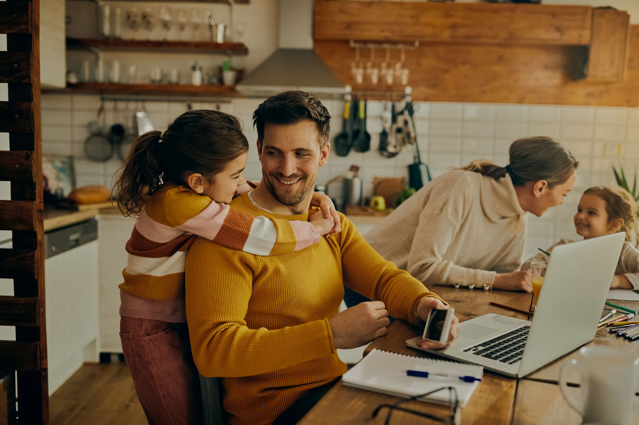 A family of four in a bright kitchen