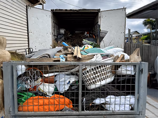 Loading rubbish truck after Hoarder Clean up