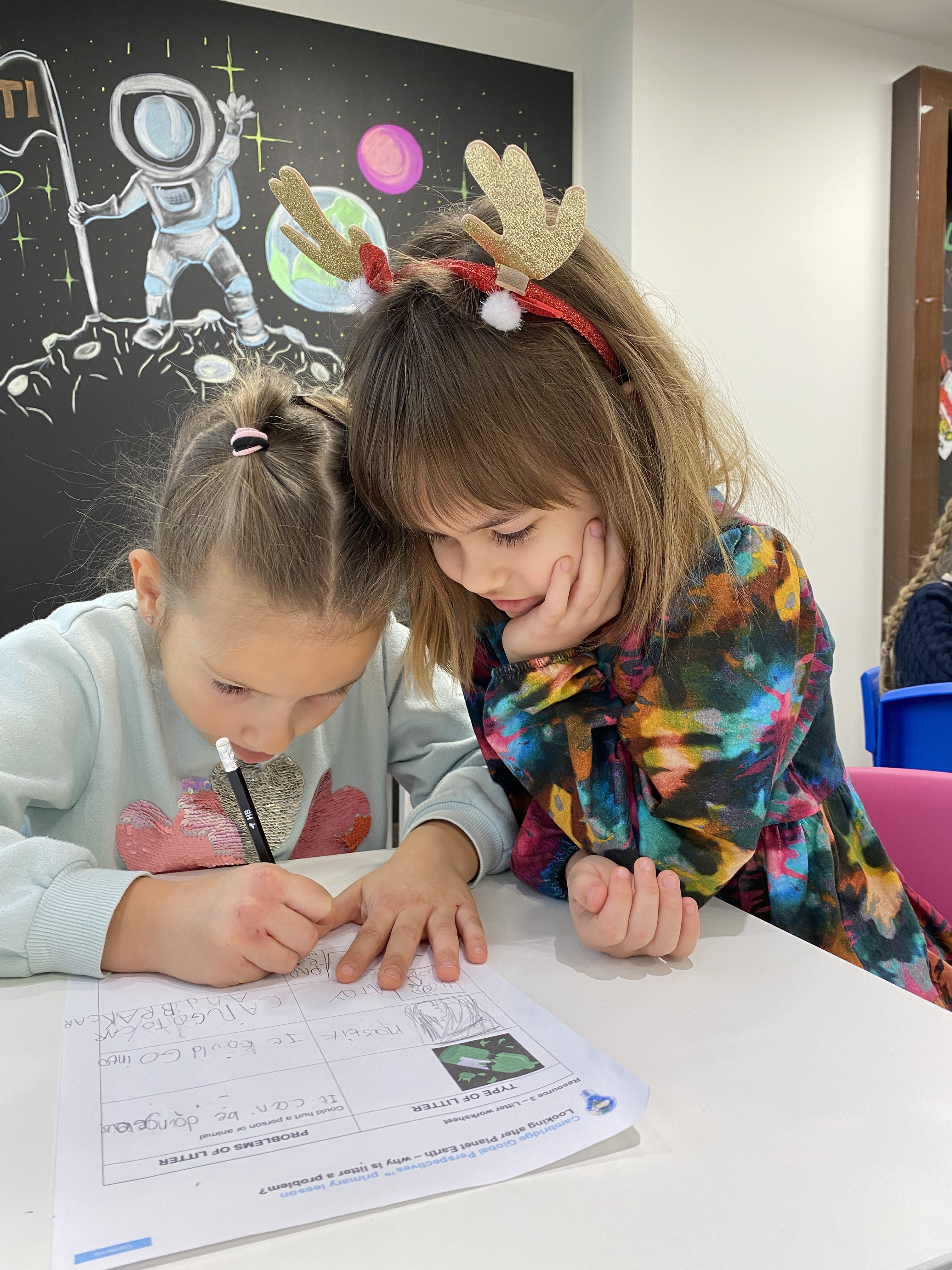 Child engaged in interactive English lesson activities at ESTI School