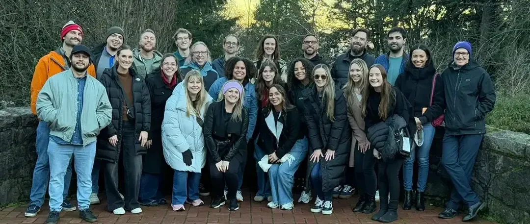 A group of Strike Graph workers standing outside in nature.