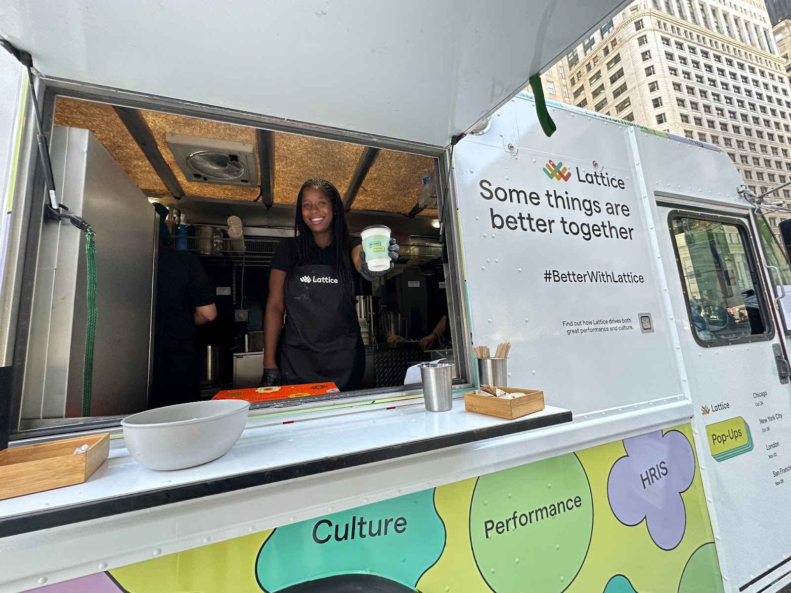 A Lattice barista handing you a coffee from a truck.