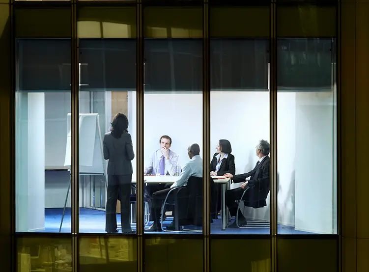 A view from outside a skyscraper of people meeting