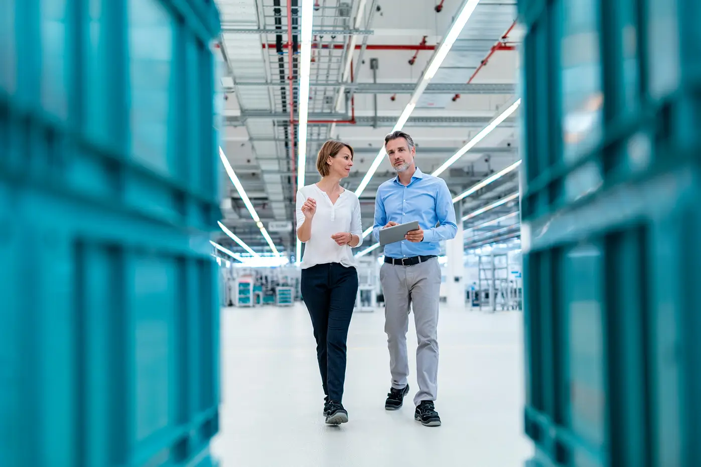 Two people walking around a warehouse