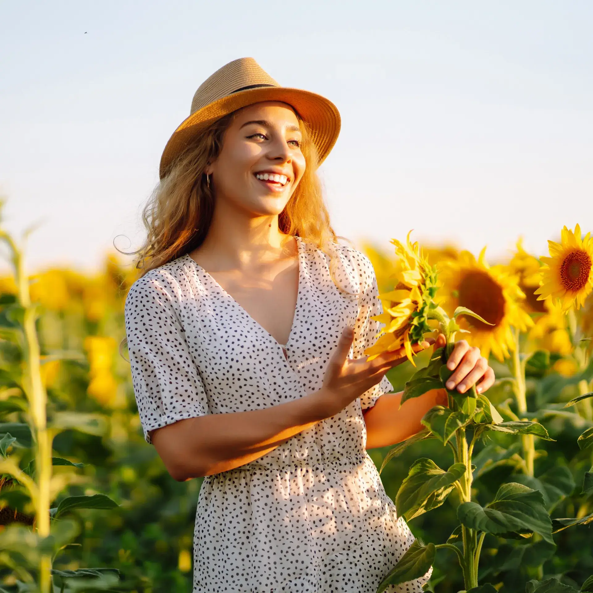 a woman standing in a field of sunflowers