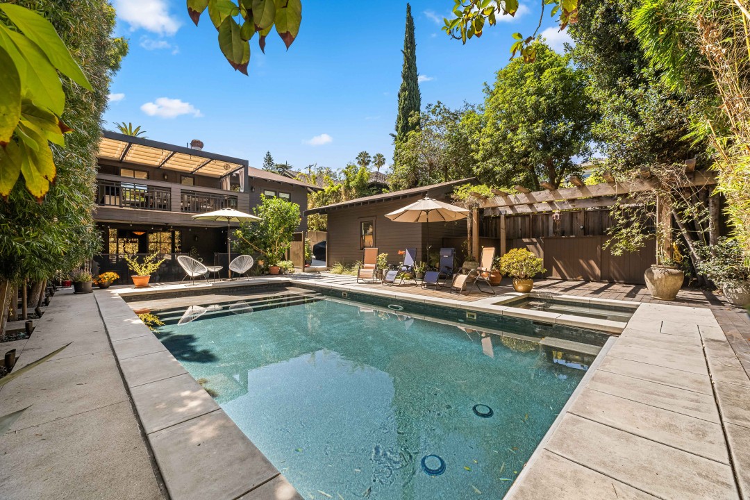 Inviting patio in Silver Lake, Los Angeles, at a Nonpareil Stays property, featuring a dining table set for a meal and comfortable lounge chairs overlooking the landscape.