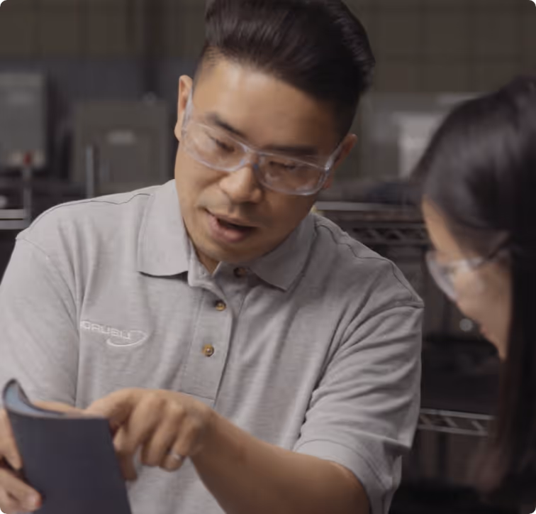 Engineers inspecting a gas turbine blade for damage before repair