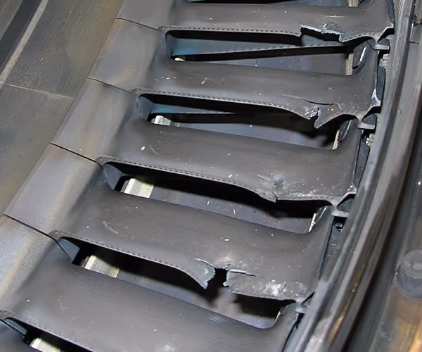 Gas turbine blades showing severe impact damage in a turbine rotor assembly