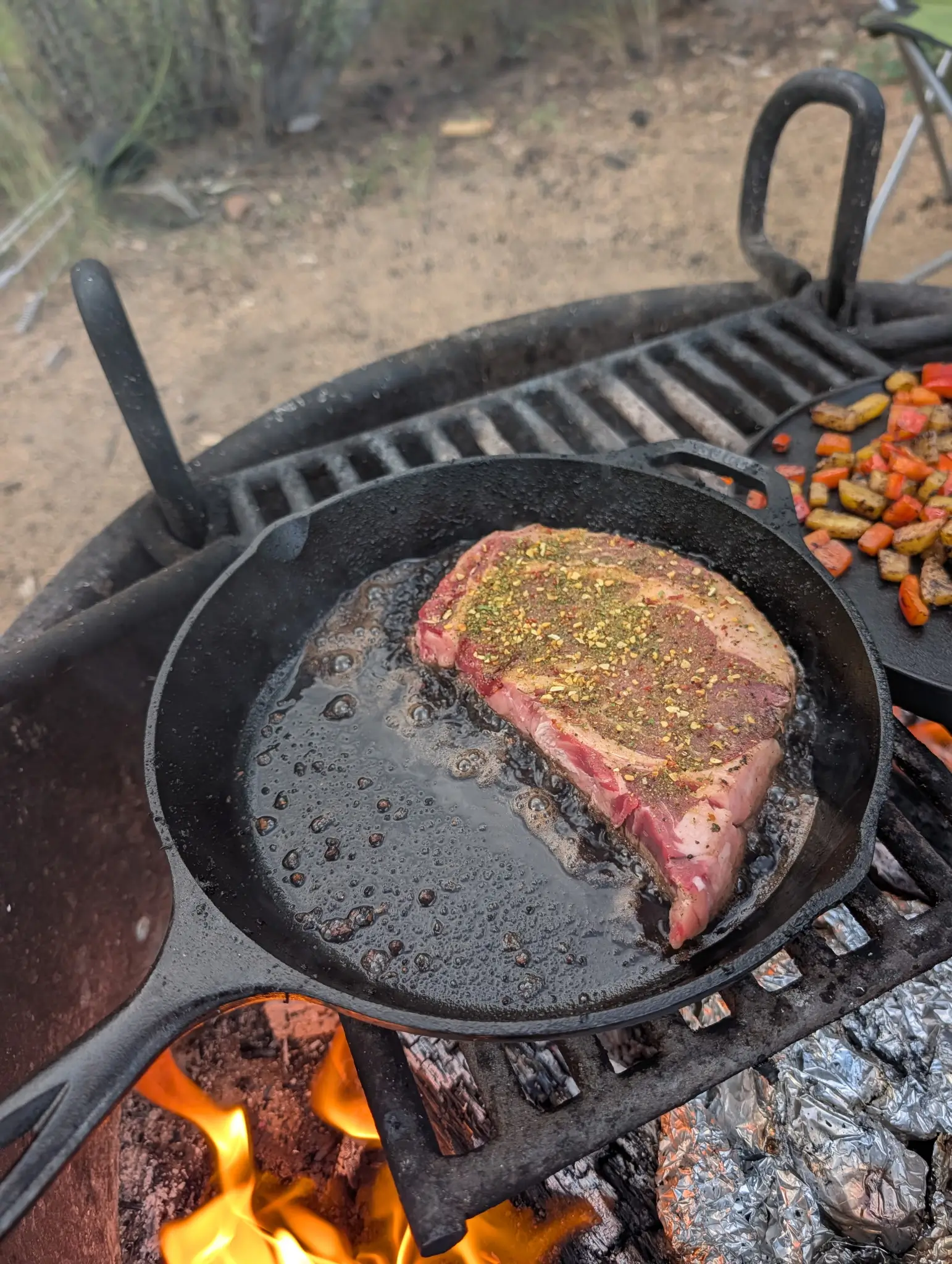 Grilling ribeyes in the skillet on Prescott House Camp Trip