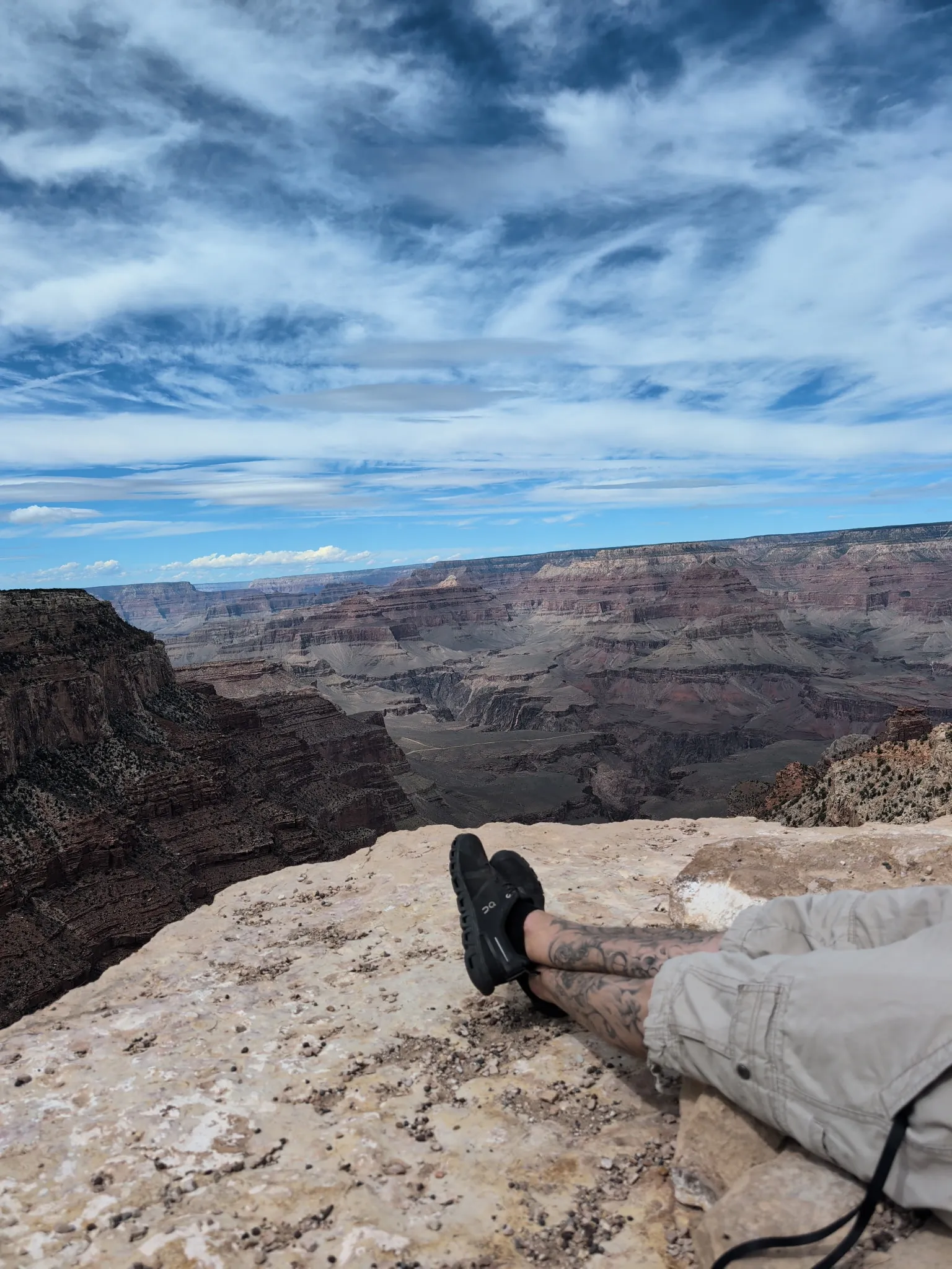 Boots propped up on the edge of the Grand Canyon South Rim during a Prescott House trip