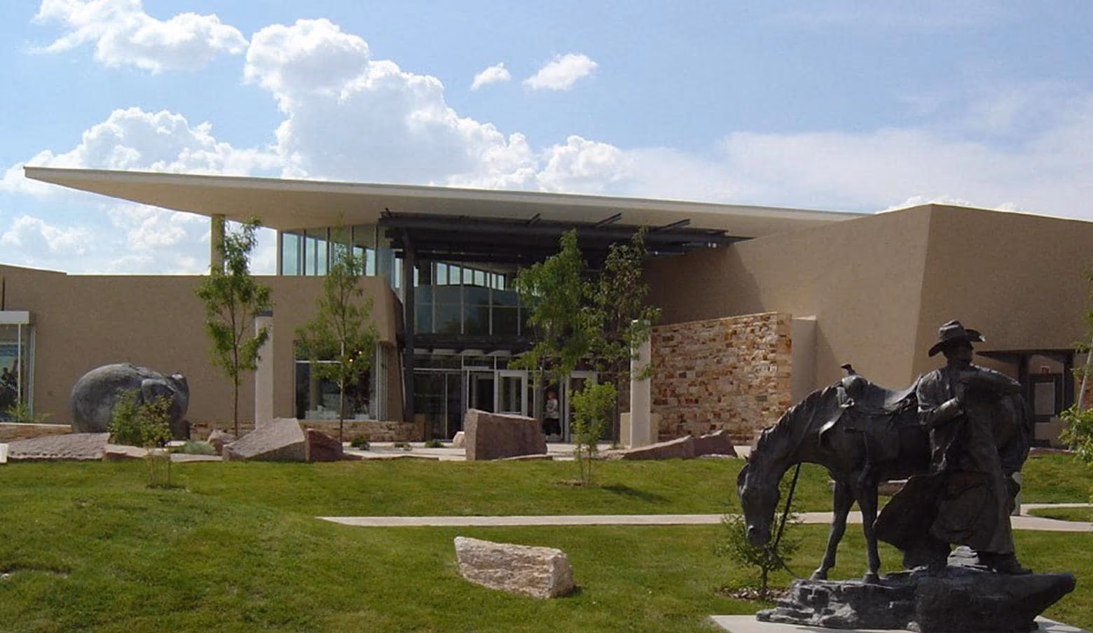 Exterior of the Albuquerque Museum of Art with sculpture of horse and cowboy