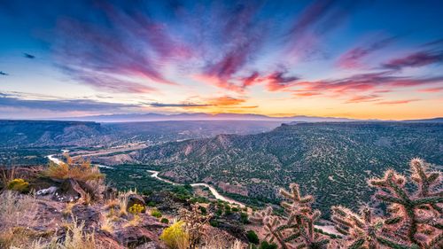 View of landscape in northern New Mexico with Rio Grande in the distance at sunset