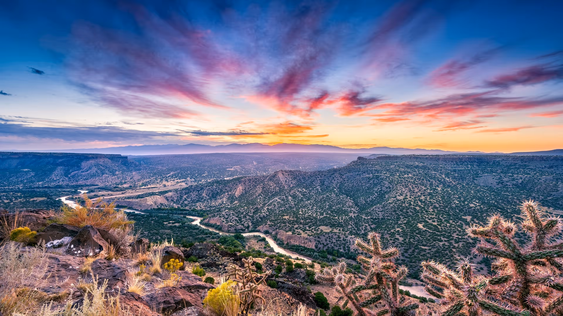 View of landscape in northern New Mexico with Rio Grande in the distance at sunset
