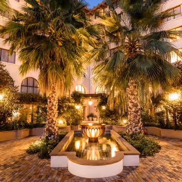 Fountain and palm trees at Hotel Encanto