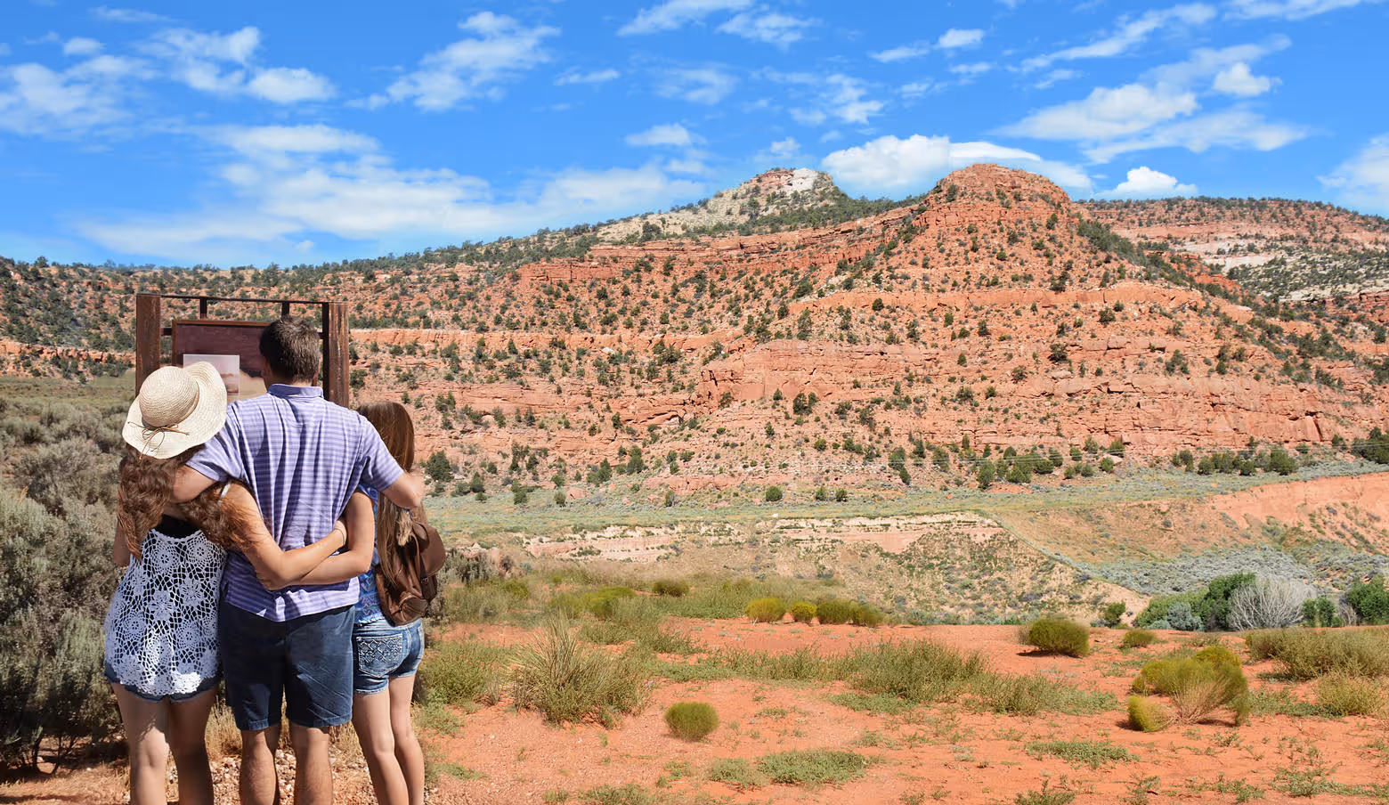 Family reading a historic marker sign