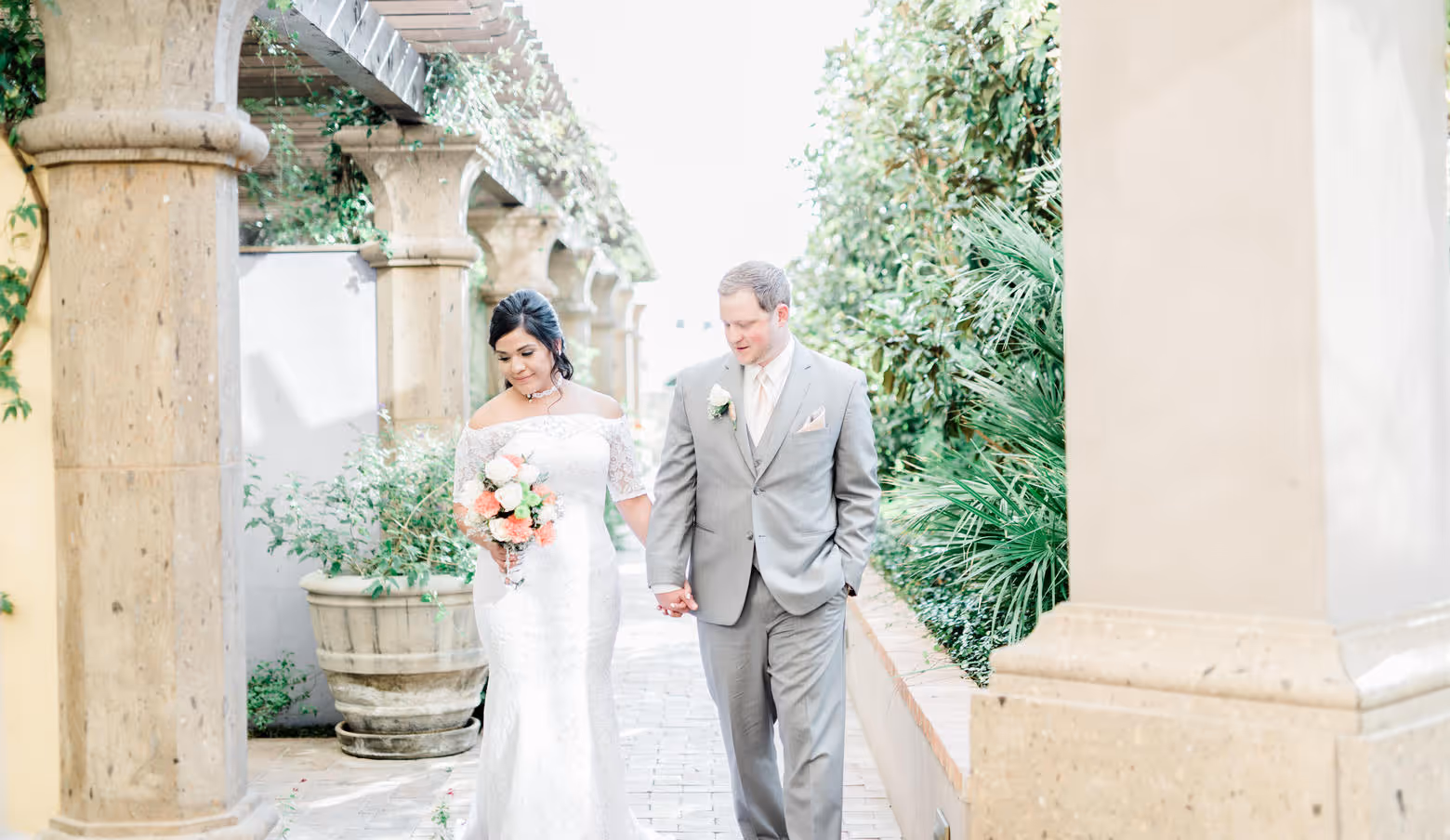 Bride and groom walking through grounds at Hotel Encanto