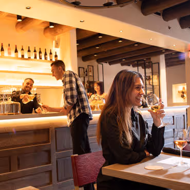 Woman having a glass of wine in Crafted Tasting Room at Inn and Spa at Loretto