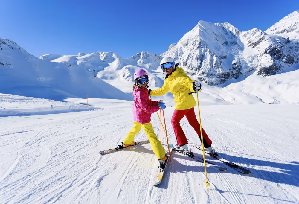 Two people on skis on snowy mountain