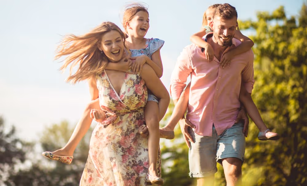 Mom and dad each with a child on their back