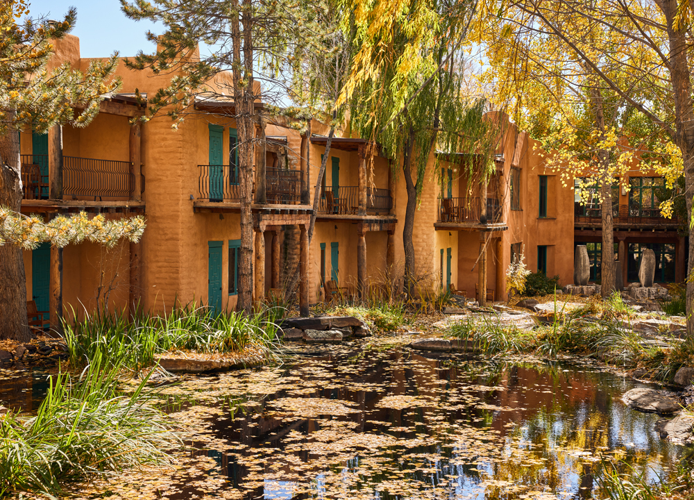 El Monte Sagrado exterior with trees and pond in fall