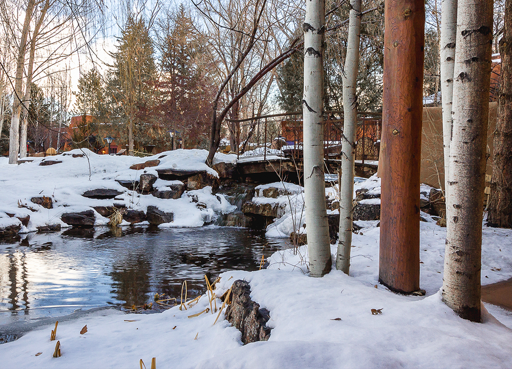Grounds of El Monte Sagrado with trees and snow