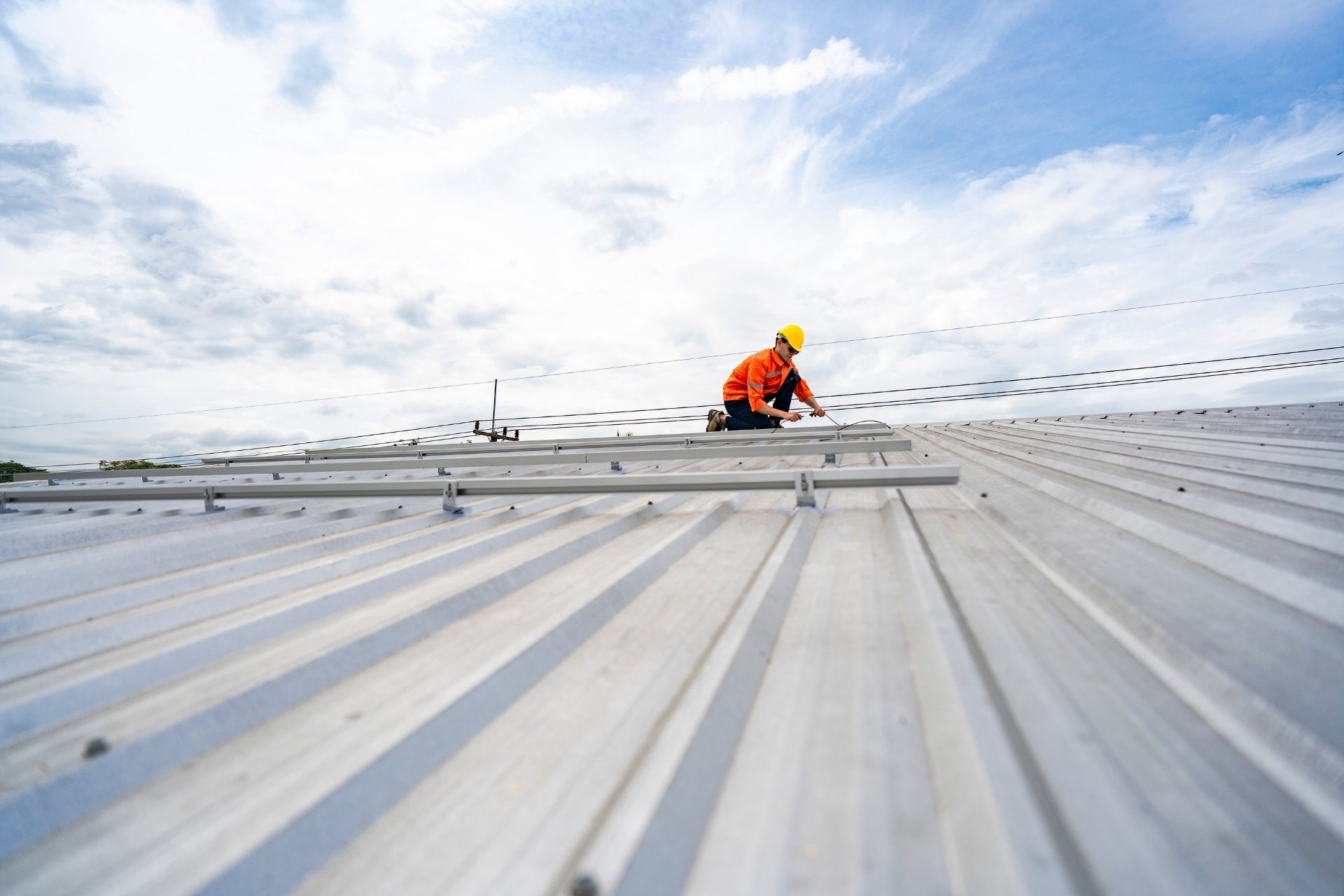 Worker performing a roof inspection and maintenance