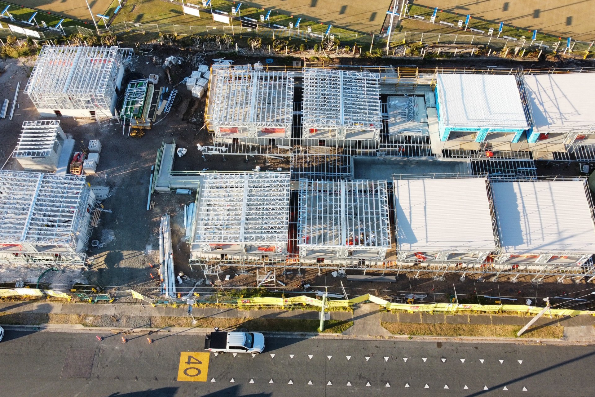 New motel development featuring rows of compact buildings with fresh white new commercial roofing.