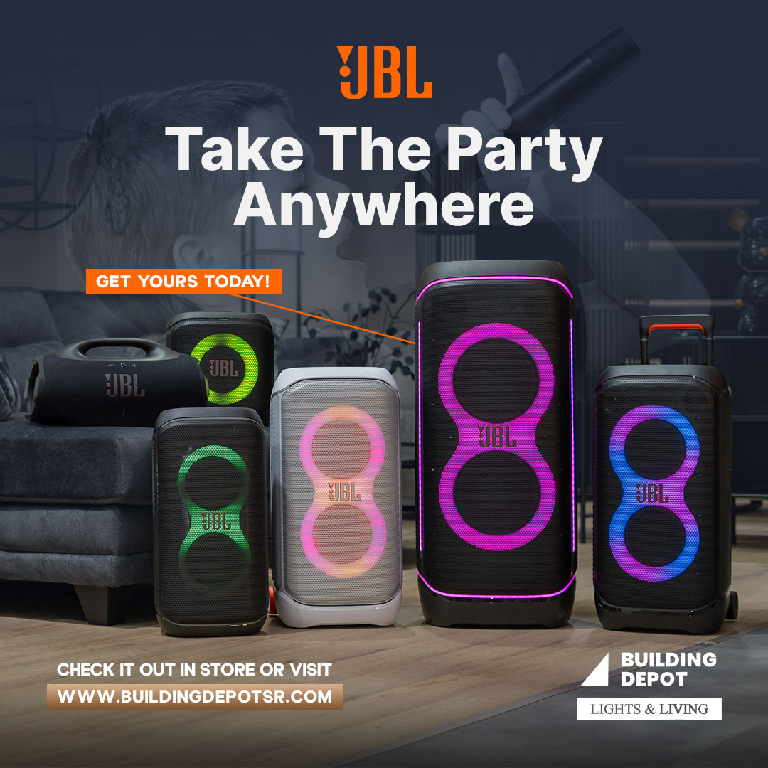 JBL speakers with colorful LED lights displayed on a floor with text 'Take The Party Anywhere' and 'Get Yours Today' for Building Depot promotion.