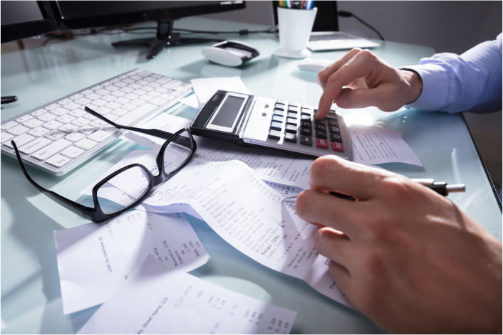 Employee looking through printed documents at his desk