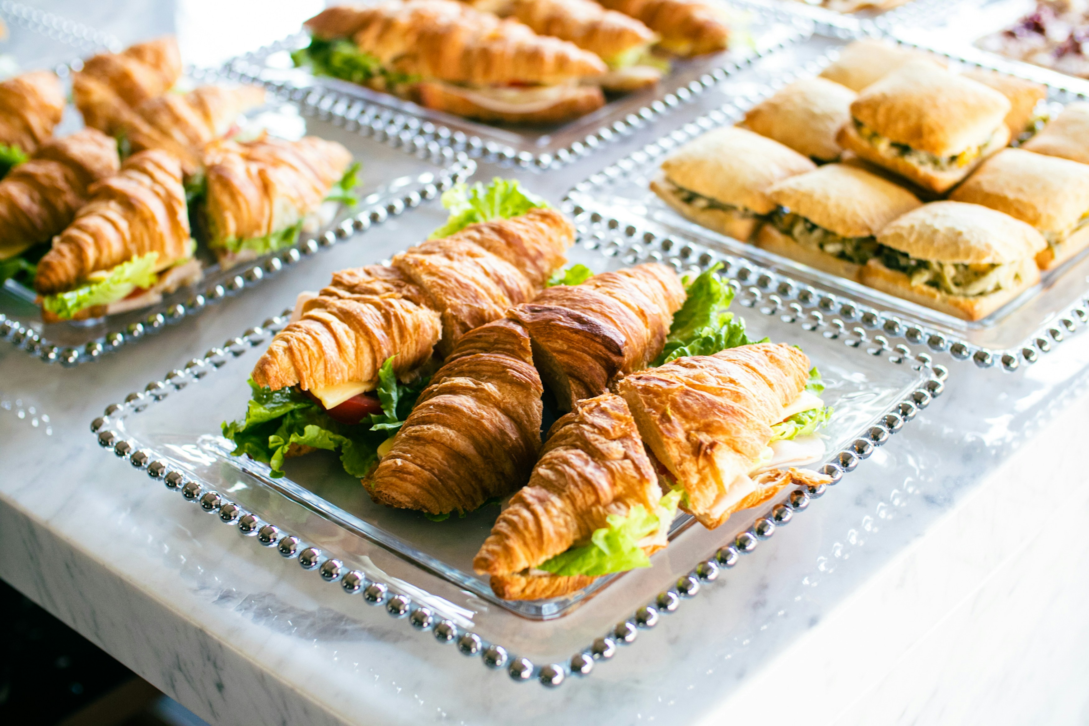 Croissant rolls and sandwiches on display