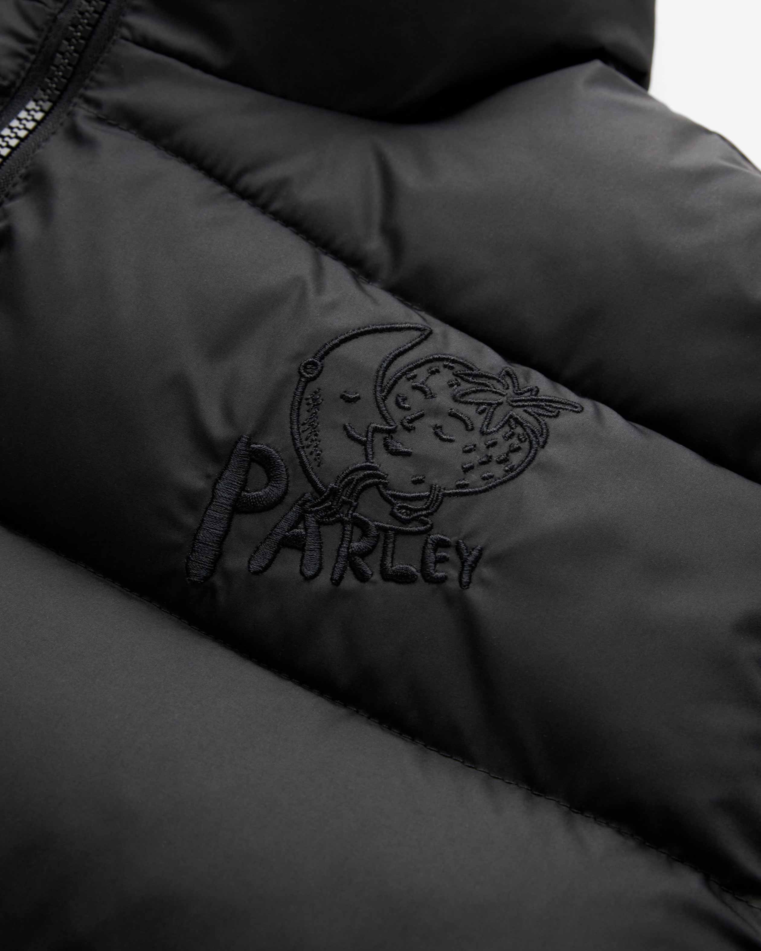 Black jacket with embroidered design of a crescent moon kissing a strawberry and the word 'PARLEY'.