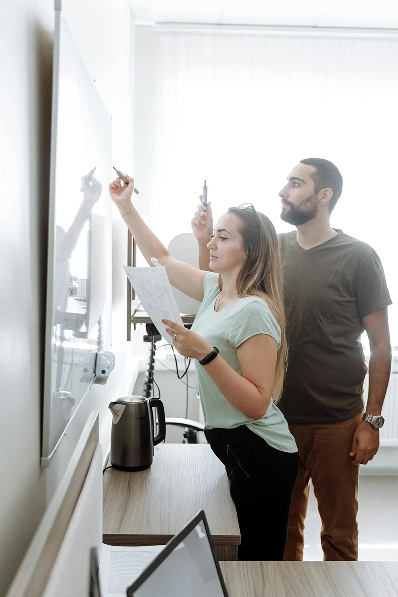 Web designers reviewing small business website development plans at a modern workstation